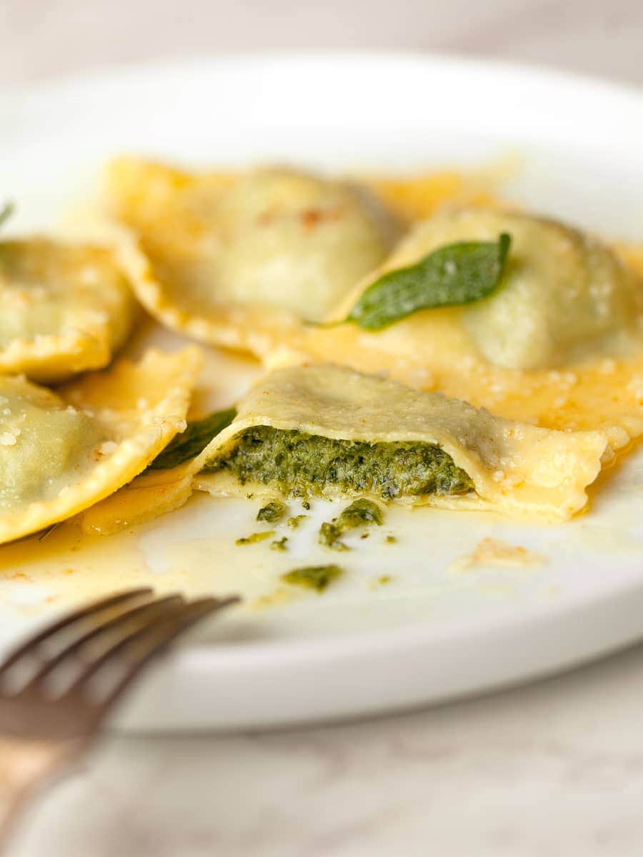 a cut open gluten free spinach ricotta ravioli