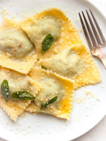 Learn how to make homemade gluten free spinach ricotta ravioli with fresh pasta dough and a creamy filling. Easy step-by-step guide.