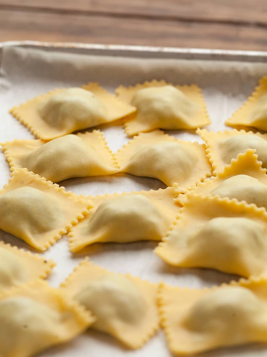 gluten free spinach ricotta ravioli on a sheet tray