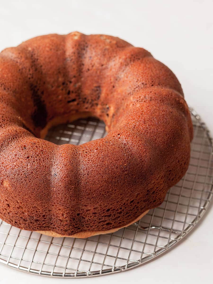 a whipped cream cake on a cooling rack