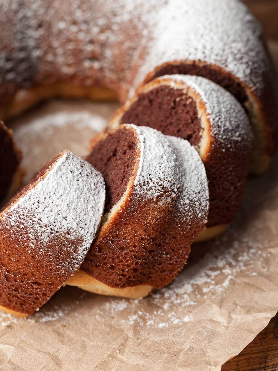 sliced whipped cream cake topped with powdered sugar