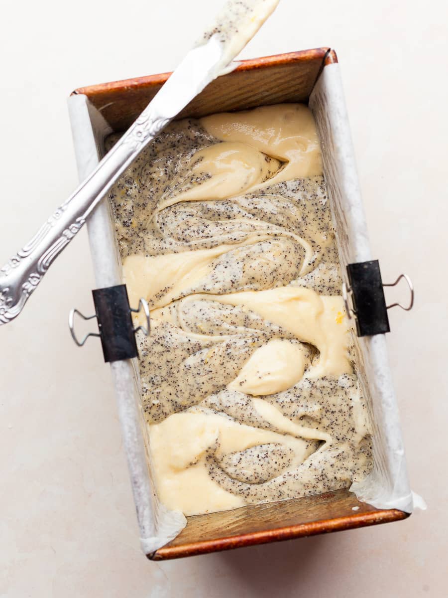 swirled lemon poppy seed cake batter in loaf pan