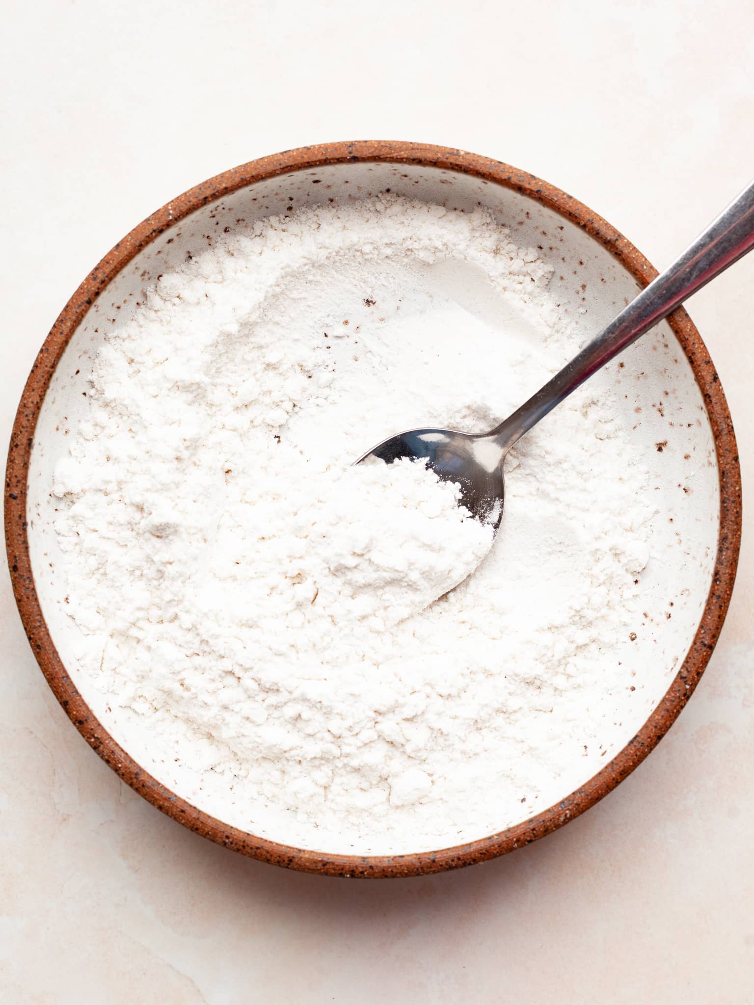 gluten free flour and a spoon in a bowl