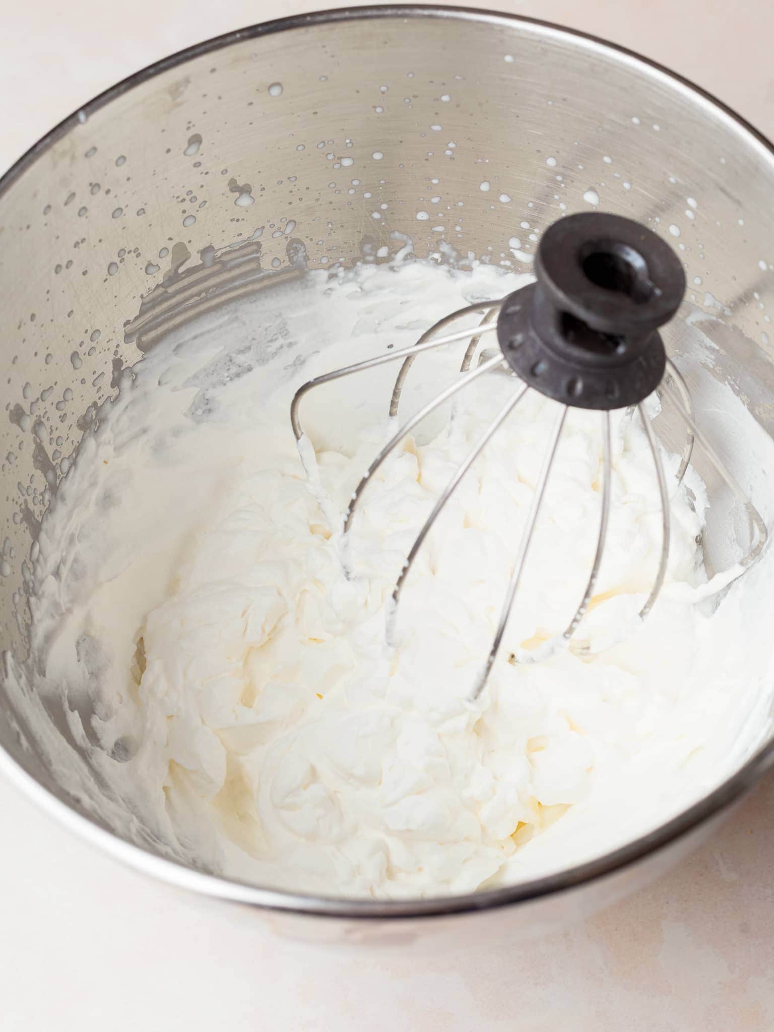 whipped cream in a kitchen aid mixing bowl