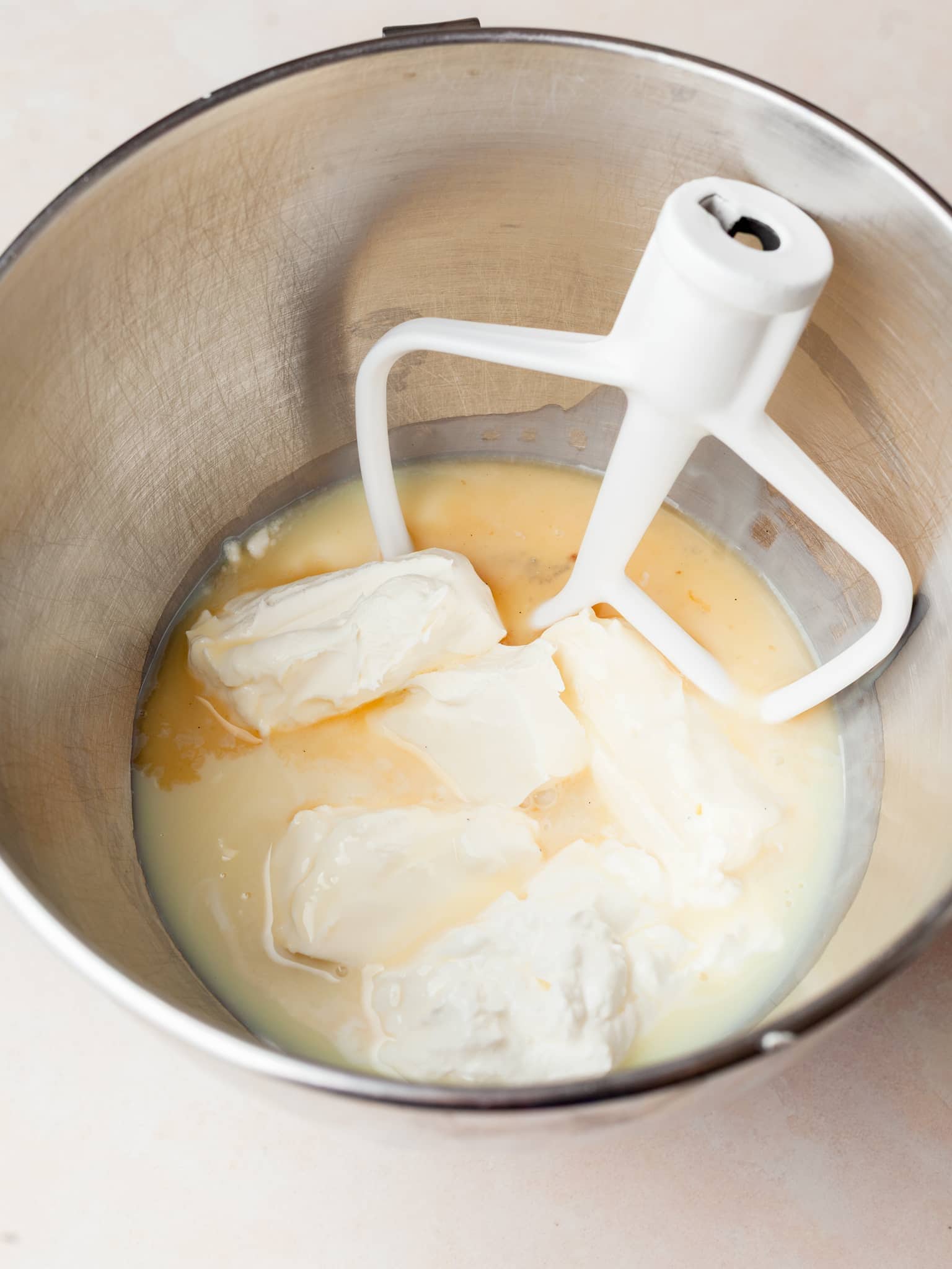 sweetened condensed milk,. softened cream cheese and sour cream in the bowl of the kitchenaid mixer
