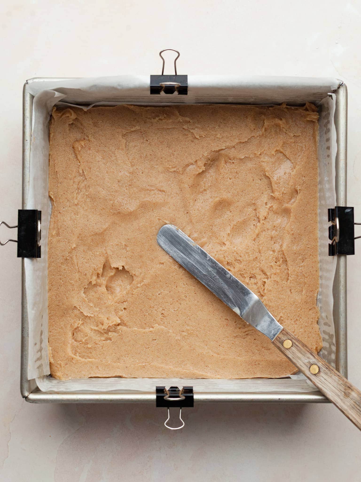 gluten free snickerdoodle cookie dough in an 8x8 baking pan