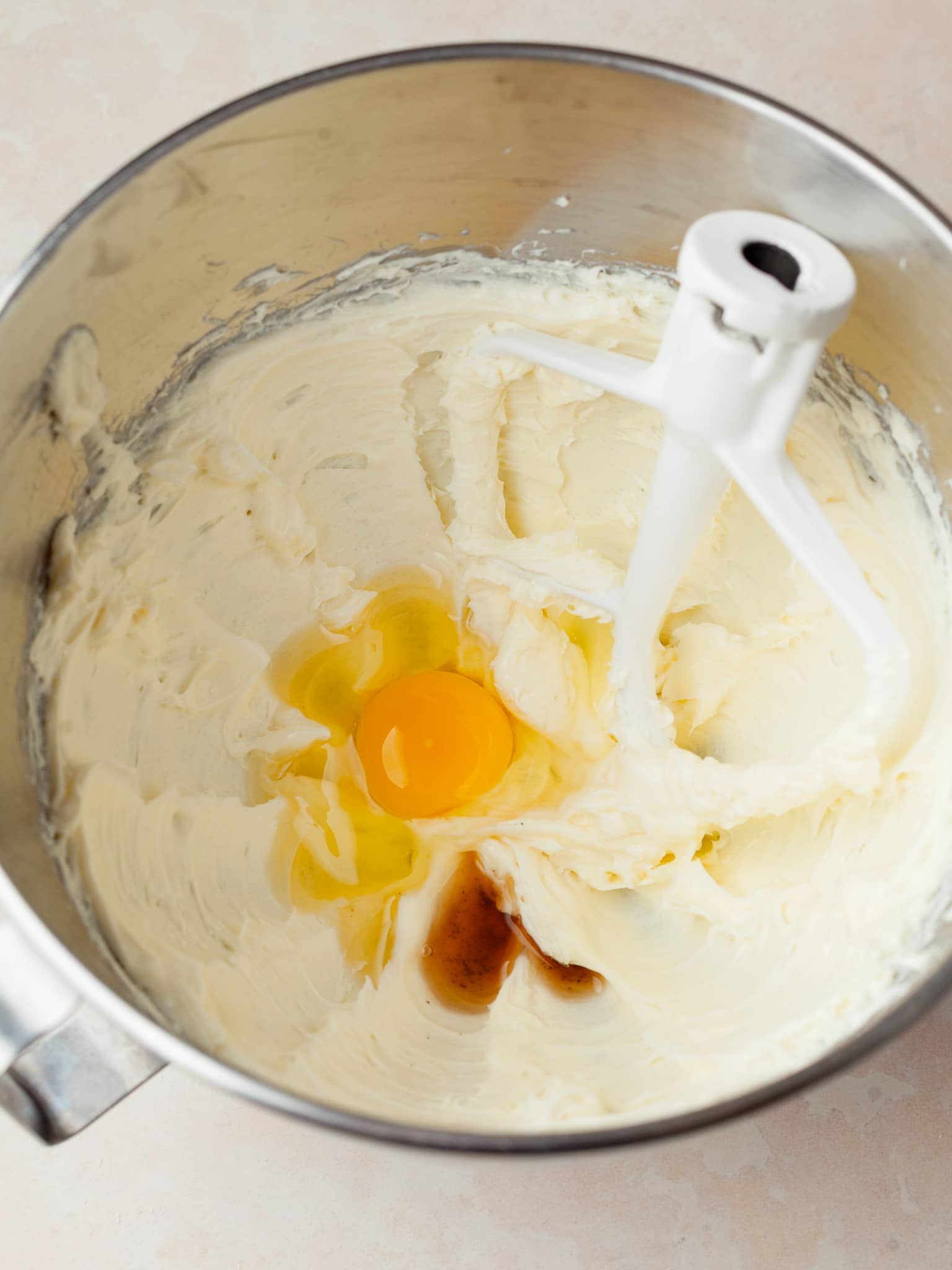 creamed cream cheese with egg and vanilla in the mixing bowl