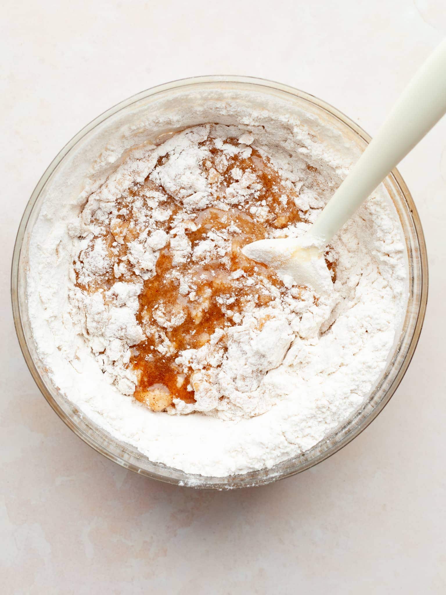 melted butter, sugar and an egg with a whisk in a bowl