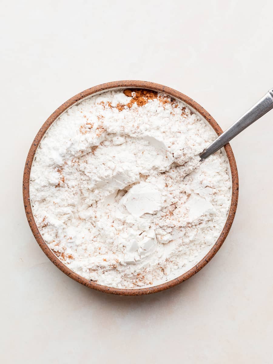 a bowl of dry ingredients needed to make gluten free pumpkin cheesecake cookies
