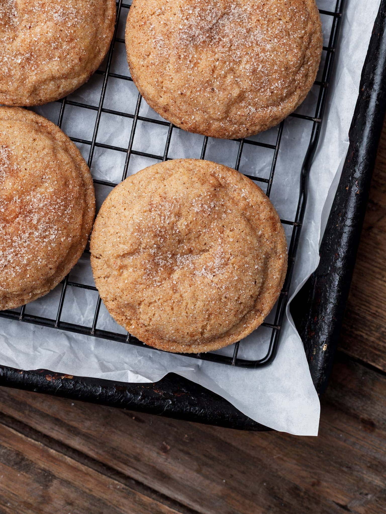gluten free pumpkin cheesecake snickerdoodle cookies on a sheet tray cooling